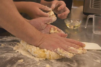 A person kneading bread