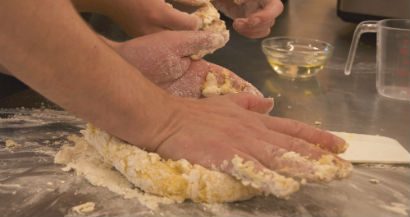 A person kneading bread