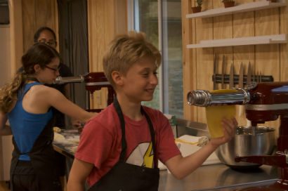 A boy making pasta