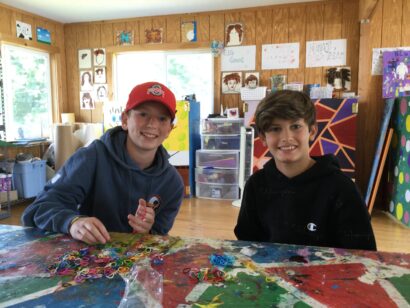 Two boys doing rubberband art