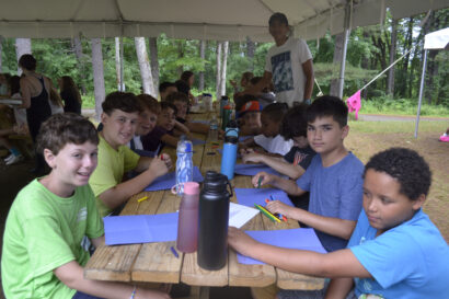 Younger kids coloring on picnic tables