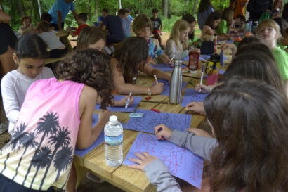 Younger kids coloring on picnic tables