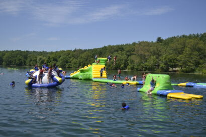 Kids playing on blow up lake playground