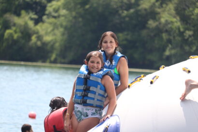 kids on a floatation device on the lake